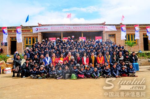 道达尔一行代表与穿上新羽绒服的学生们合影